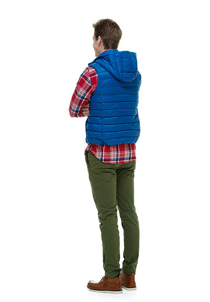istock Rear view of man standing with arms crossed 536972031