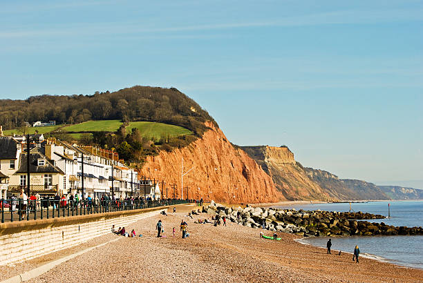 Sidmouth seafront with red cliffs of Jurassic Coast, Devon England Sidmouth seafront with red cliffs of Jurassic Coast, Devon England, United Kingdom jurassic coast world heritage site stock pictures, royalty-free photos & images
