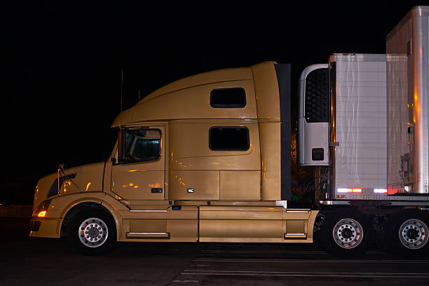 istock Profile-of-contemporary-elegance-semi-truck-with- night-lights-reflection 536976111