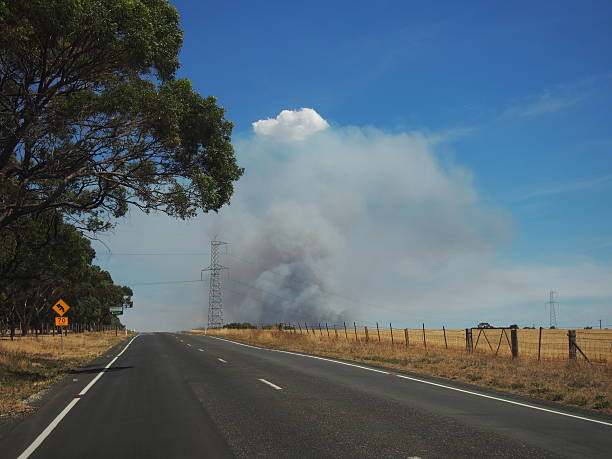 Plume of smoke looming over beautiful hilly country side in South Australia