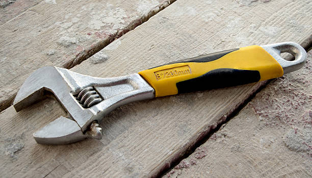 istock Wrench on wooden boards 536978085