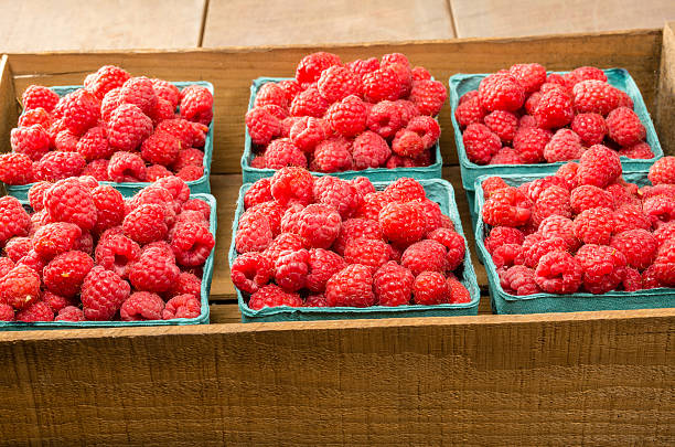 Fresh red raspberries on display at the market