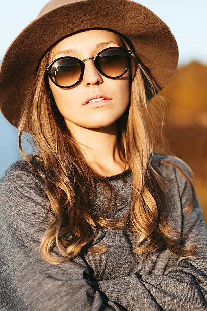 girl in hat outside stock photo