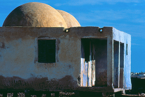 a slide scanned from a view of an old and abandoned building by the sea in Djerba