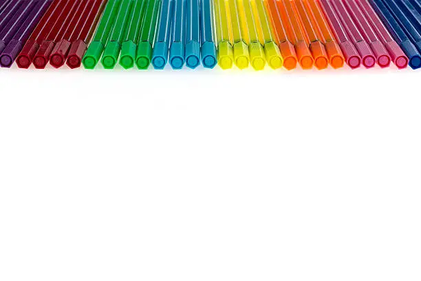 Colored pens lying on a white background