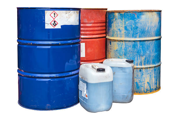 Toxic waste barrels isolated on white Rusty toxic waste barrels isolated on a white background drum container stock pictures, royalty-free photos & images