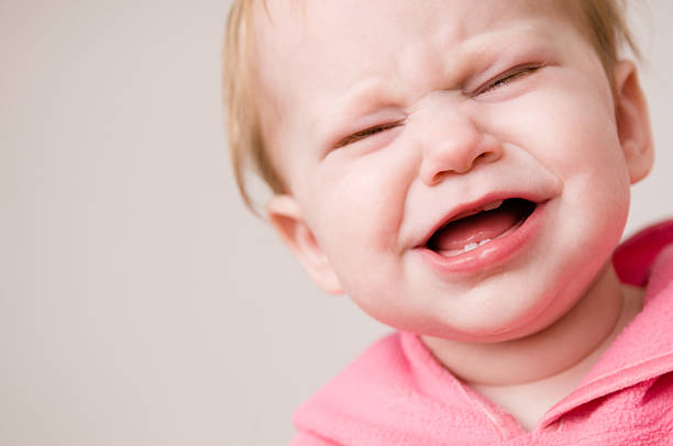 istock Crying Baby Suffering Through Pain of Teething 537019347