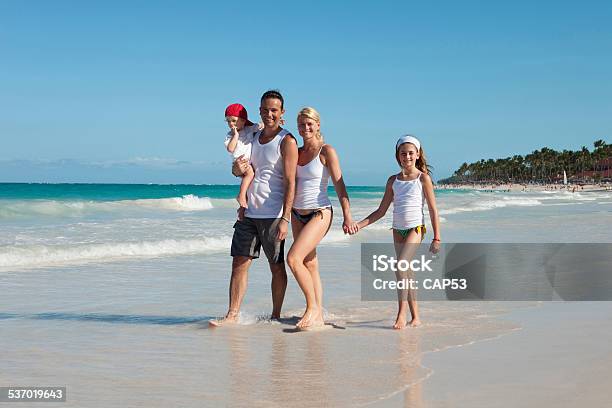 Young Family On A Tropical Beach Stock Photo - Download Image Now - 2015, Adult, Baby - Human Age