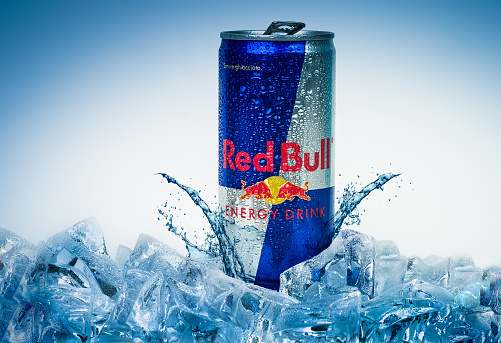 Trieste, Italy - May 29, 2016:  Aluminium can of Red Bull Energy drink iced Background.Red Bull is the most popular energy drink in the world, with 5,226 billion cans sold in 2012.