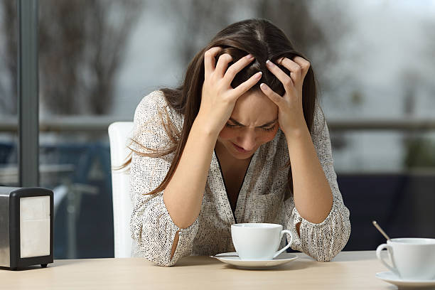 istock Sad and depressed woman alone in a coffee shop 537022764