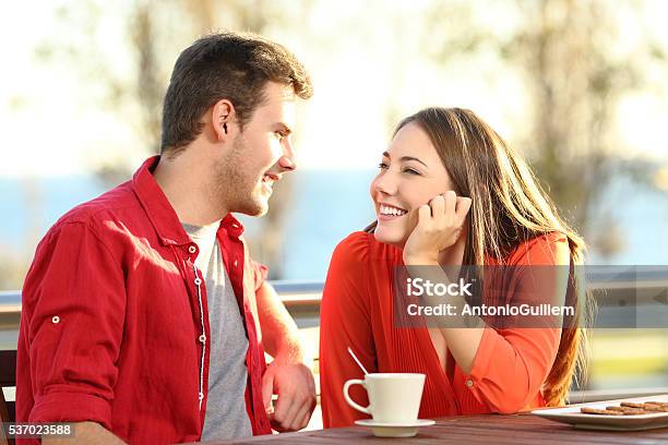 Candid Couple In Love Flirting In A Terrace Stock Photo - Download Image Now - Love At First Sight, Adult, Beautiful People