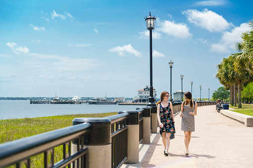 Two teenager girls walks in the Waterfront Park in Charleston, South Carolina