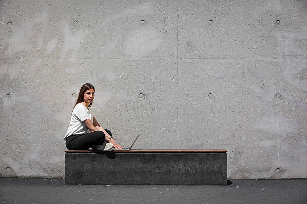 istock girl, laptop, concrete 537036010