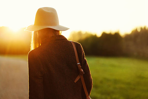 istock girl walking down in sunset light 537039285