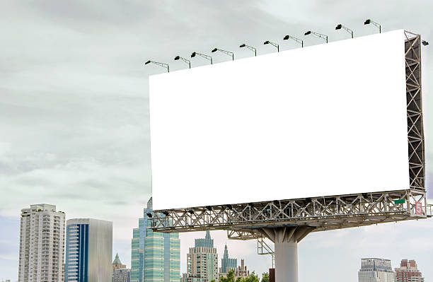 istock large blank billboard on road with city view background 537040783