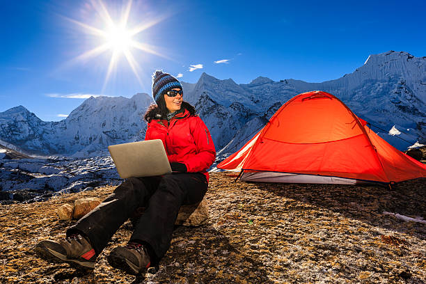 istock Young woman using laptop in Himalayas, Nepal 537040956