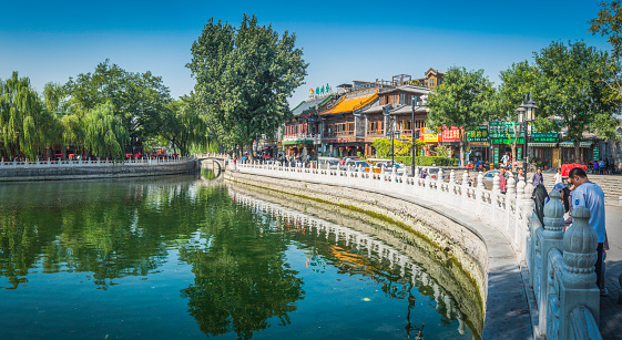 Beijing, China - 26th September 2013: People enjoying the sunshine at the colourful restaurants, bars and cafes along the promenade beside the Qianhai Sea lake, the popular leisure destination in the heart of downtown Beijing, China's vibrant capital city. Composite panoramic image created from five contemporaneous sequential photographs. 