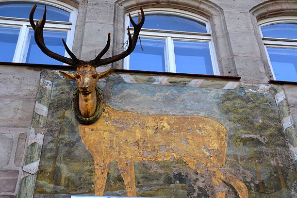 Nurnberg, Germany - August 11, 2014: A curious deer art composition on a building's wall, Nurnberg historical city centre