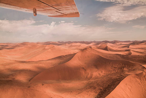 Sand desert dunes in Namibia Sand desert dunes in Namibia, Africa. Landscape image taken from the airplane, huge desert, nobody in the scene. namib sand sea stock pictures, royalty-free photos & images