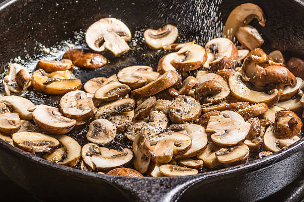 istock Sauteing sliced mushrooms in a skillet 537045119