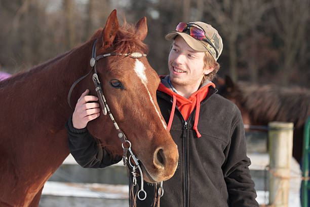 istock Young man gently embraces and smiles at his horse 537045155