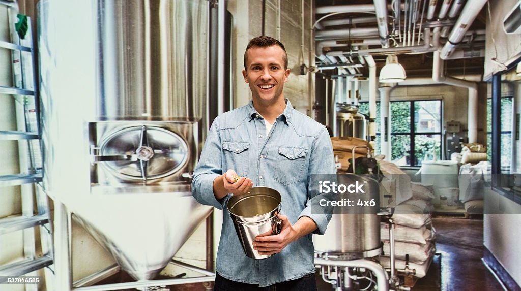 Smiling brewmaster in factory Smiling brewmaster in factoryhttp://www.twodozendesign.info/i/1.png 2015 Stock Photo