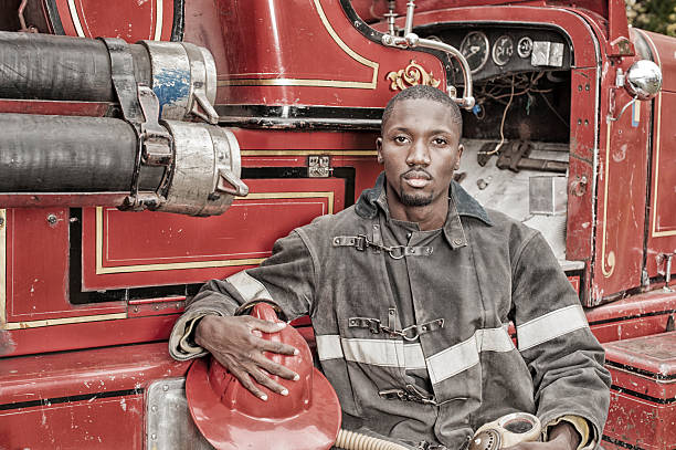 Black African American Firefighter From 1940 to 1960, Fire Truck. Black African American Firefighter From 1940 to 1960, Fire Truck. 1930s style men image created 1920s old fashioned stock pictures, royalty-free photos & images