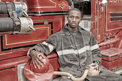 Black African American Firefighter From 1940 to 1960, Fire Truck.