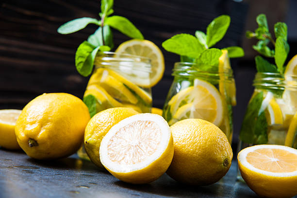 istock Composition of lemonades, lemons and mint on stone table background 537059354