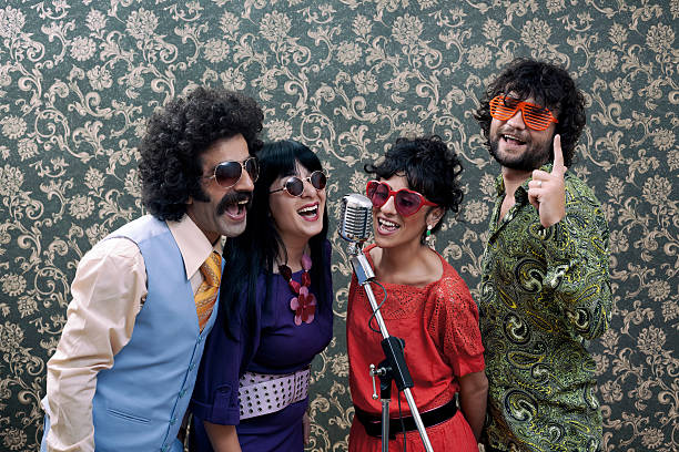 istock Three friends in seventies style singing on old fashioned microphone 537061789