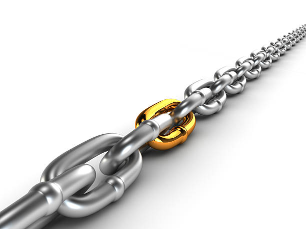 Chrome chain with a gold link stock photo