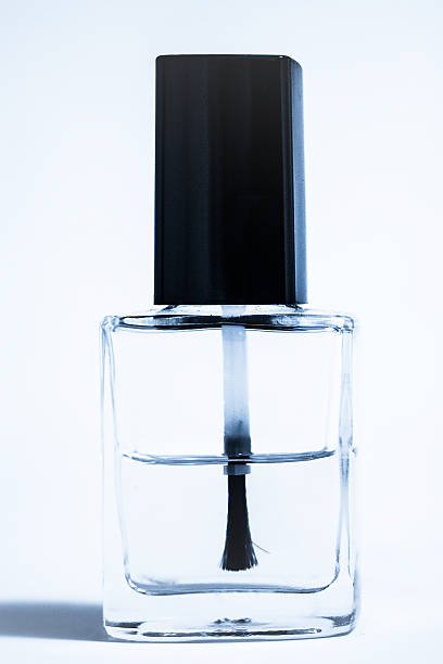 A bottle with spilled clear nail polish on white background. nail lacquer. Nail manicure concept. Isolated, copy space.