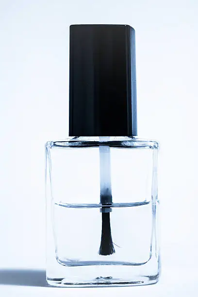 Transparent nailpolish brush with bottle, isolated on white.