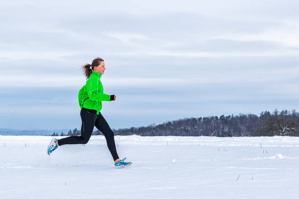 istock young woman jogging in snow 537074013