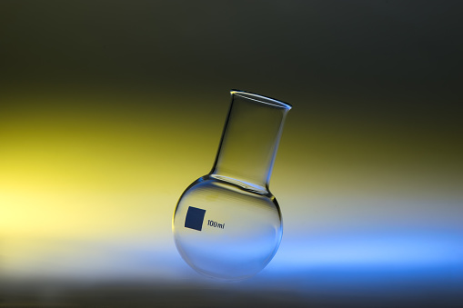 single round-bottom flask illuminated with colored flashes