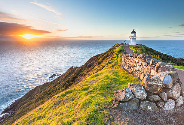 Cape Reinga Cape Reinga at Sunset. tasman sea stock pictures, royalty-free photos & images