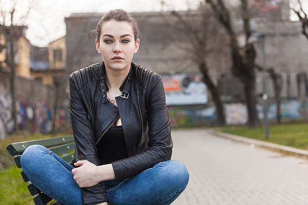 istock Beautiful girl with gorgeous eyes sitting on a bench 537077459