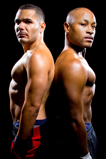 black boxer posing with latino opponent on a black background