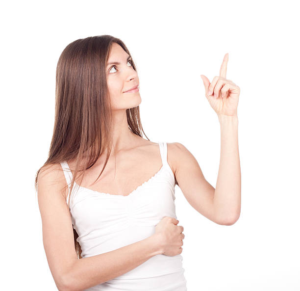 istock Beautiful brunette woman points a finger up 537078929
