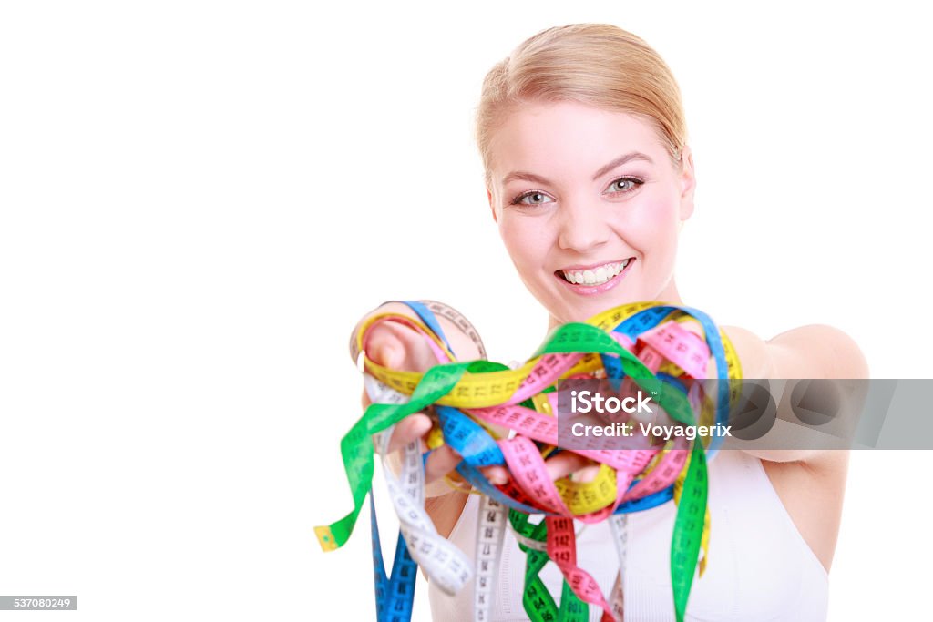 Fitness woman fit girl holding colorful measure tapes Time for diet slimming weight loss. Health care healthy lifestyle. Sport fitness woman fit girl holding a lot of colorful measure tapes isolated on white 2015 Stock Photo