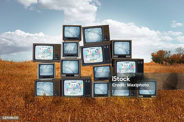 Old Televisions Stacked In The Middle Of Grass Field Stock Photo - Download Image Now