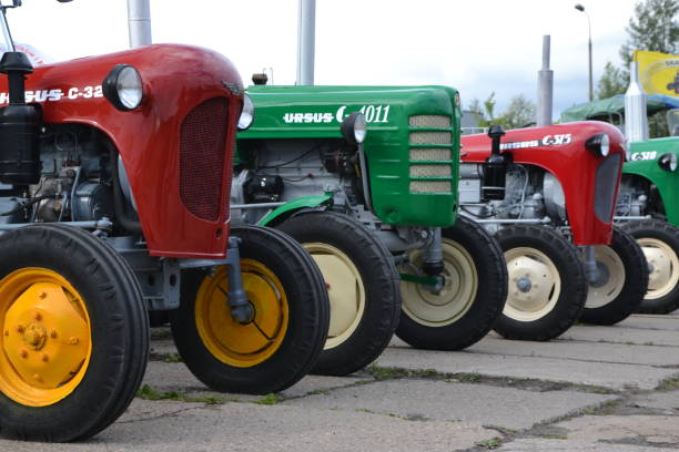 Classic tractors in a row Warsaw, Poland - 14th June, 2014: Classic tractors from Ursus brand stopped on the parking during the tractors parade. The Ursus Factory was founded in Poland in 1893. In the years 1970-1990 Ursus was one of the biggest tractors producers in the world. ursus tractor stock pictures, royalty-free photos & images