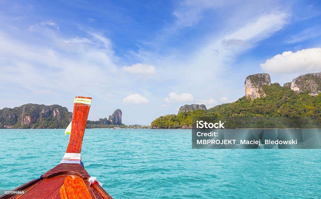 Wooden boat and a tropical island in distance. 2015 Stock Photo