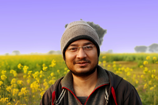 Farmer Standing Portrait in Mustard field.