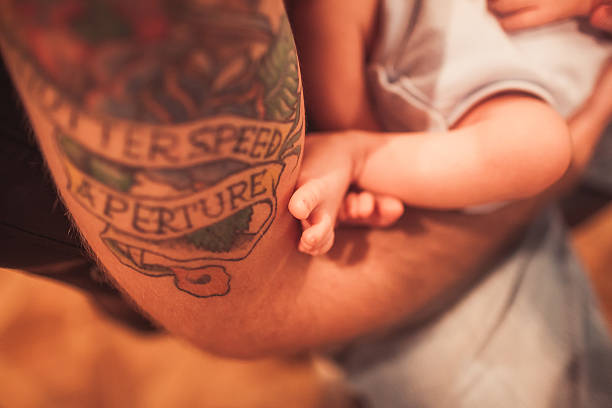 Newborn baby in father hands stock photo