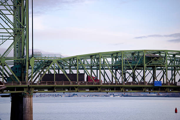 istock Arched section bridge support moving red semi truck black trailer 537096359