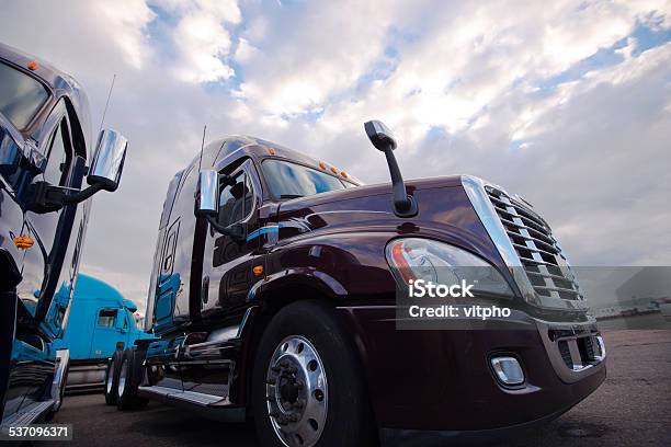 Big Rig Semi Trucks Standing On Trakstope Background Cloudy Sky Stock Photo - Download Image Now