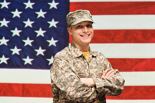 istock Smiling army man in front of American flag 537096667