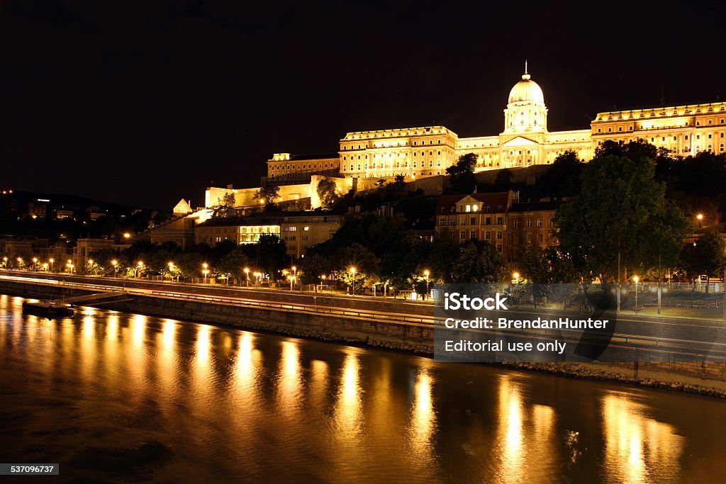 Historical Border Budapest, Hungary - June 16, 2014: The Buda Castle Hill and the banks of the Danube River, at night. Once the seat of royal power, the Buda Castle now houses a variety of Hungarian government buildings including multiple museums, a cultural center and the national library. 2015 Stock Photo