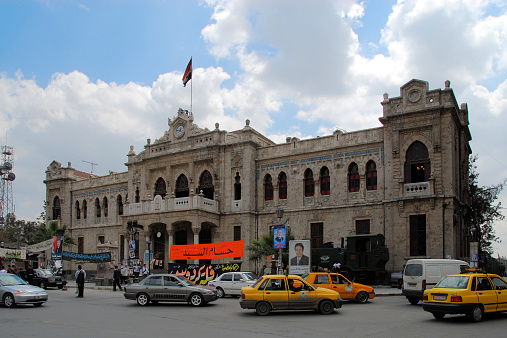 Damascus, Syria - April 9, 2007: traffic, people and political posters at Hejaz Train Station, starting point of the Hejaz railway